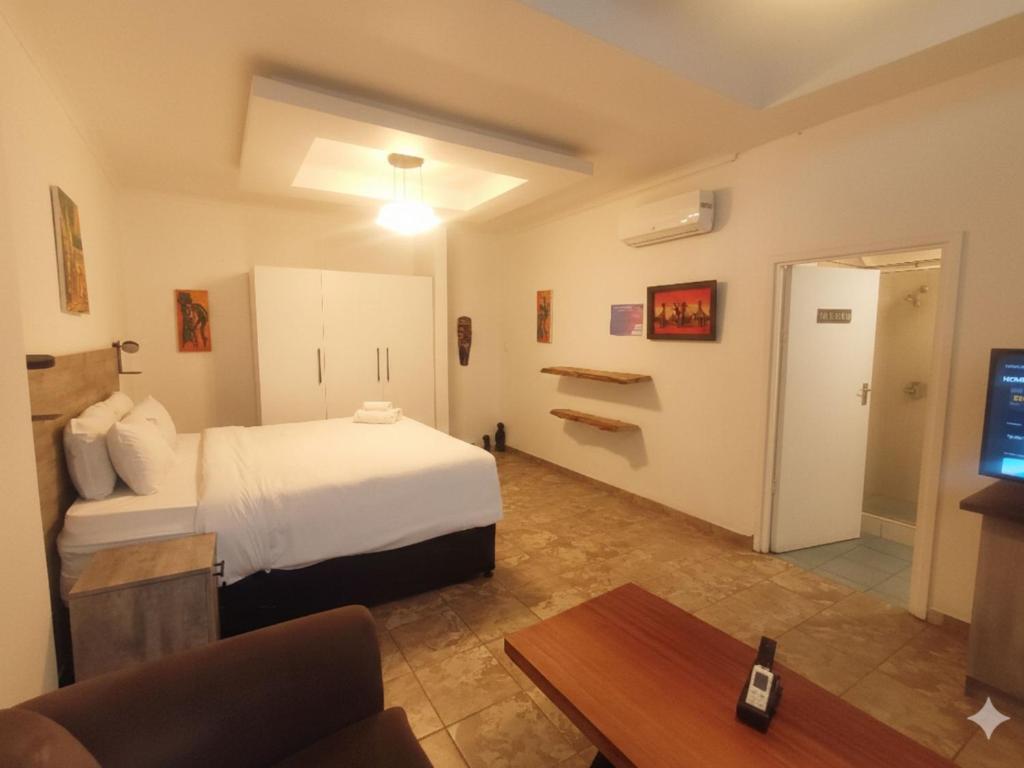 a hotel room with a bed and a tv at Michelangelo - Zur See in Ballito