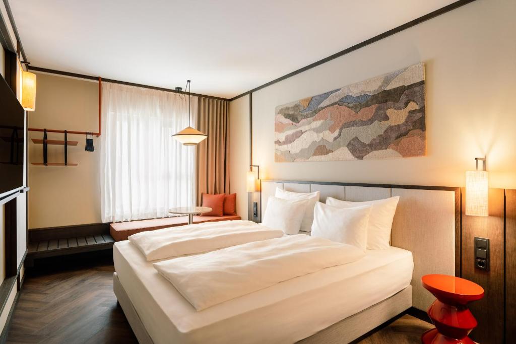 a bedroom with a large white bed in a room at Hotel Schani City in Vienna