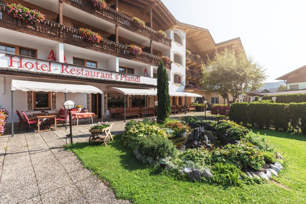 a hotel restaurant with a fountain in the yard at Bergidyll & Hotel Trofana in Leutasch