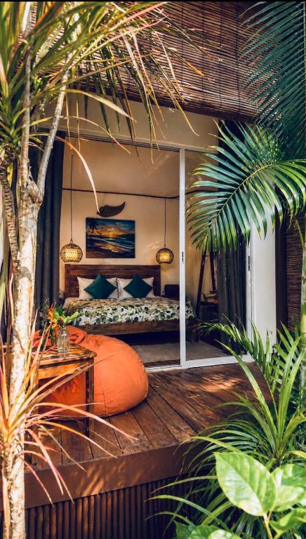 a bedroom with a bed with an orange pillow at Bella Athena Garden in El Nido