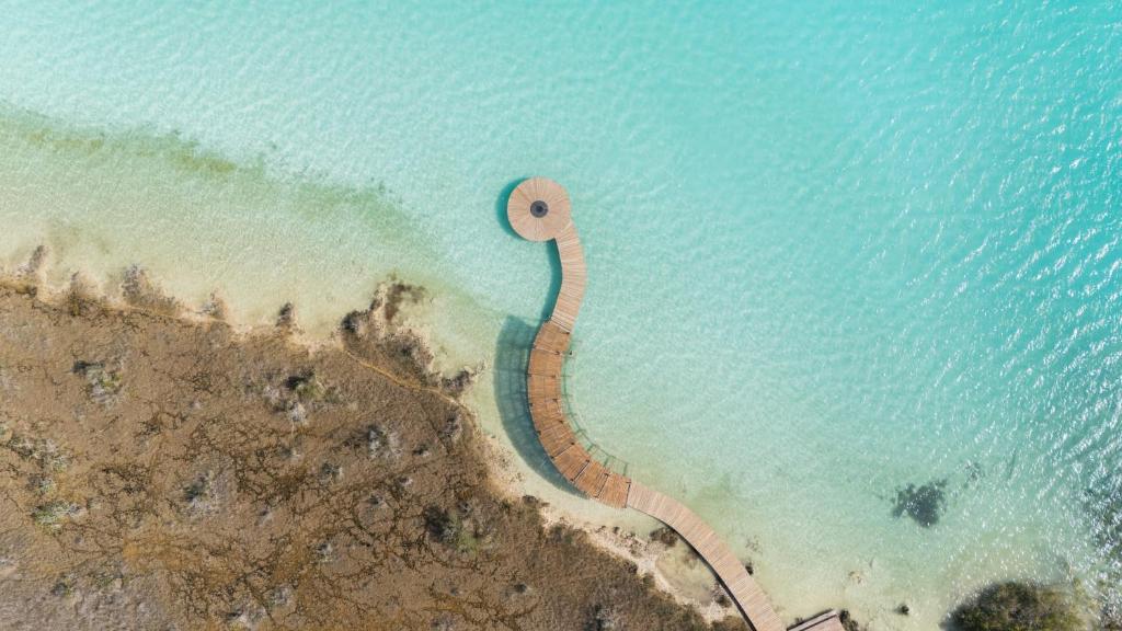 an aerial view of a beach with a path in the water at Aldea Mayab Luxury Residences by Lagoona in Bacalar