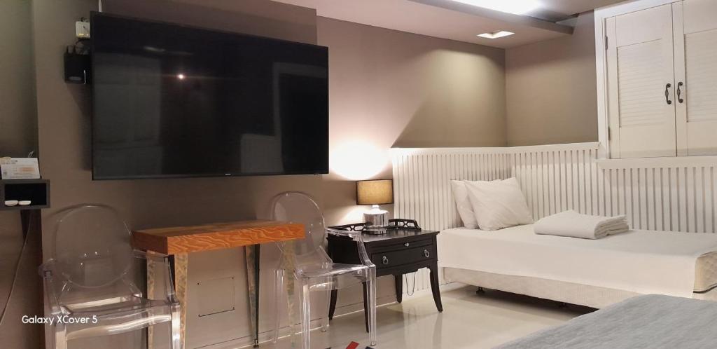 a bedroom with a bed and a desk and a tv at 김천747모텔 in Pusang