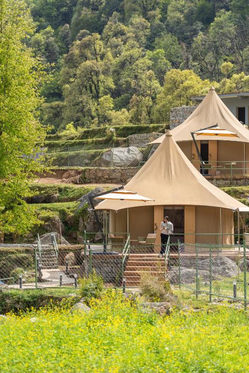 two people standing in front of a safari tent at Saraaya Glamps, Dharamshala in Dharamshala