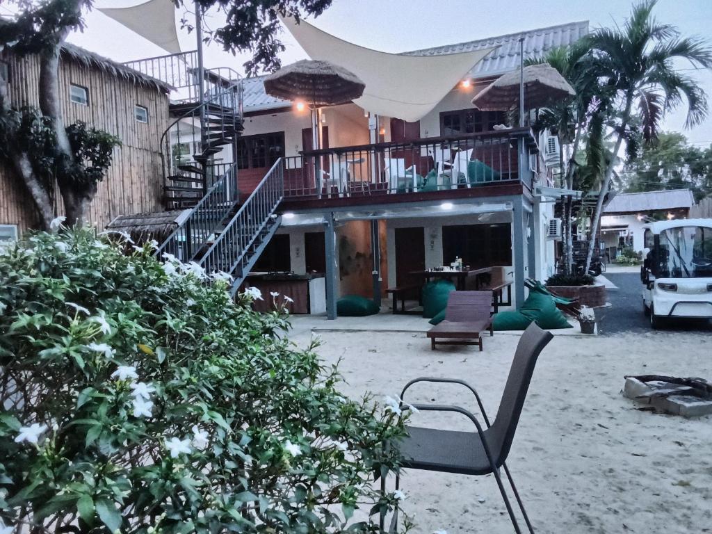 a chair sitting in front of a house at Ladybugs hostel sunset in Taling Ngam Beach