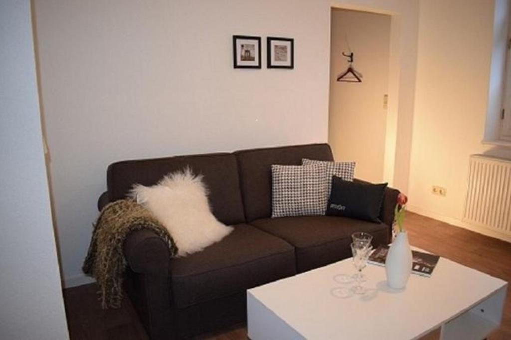 a living room with a couch and a table at Stadtapartement Geisa in Geisa