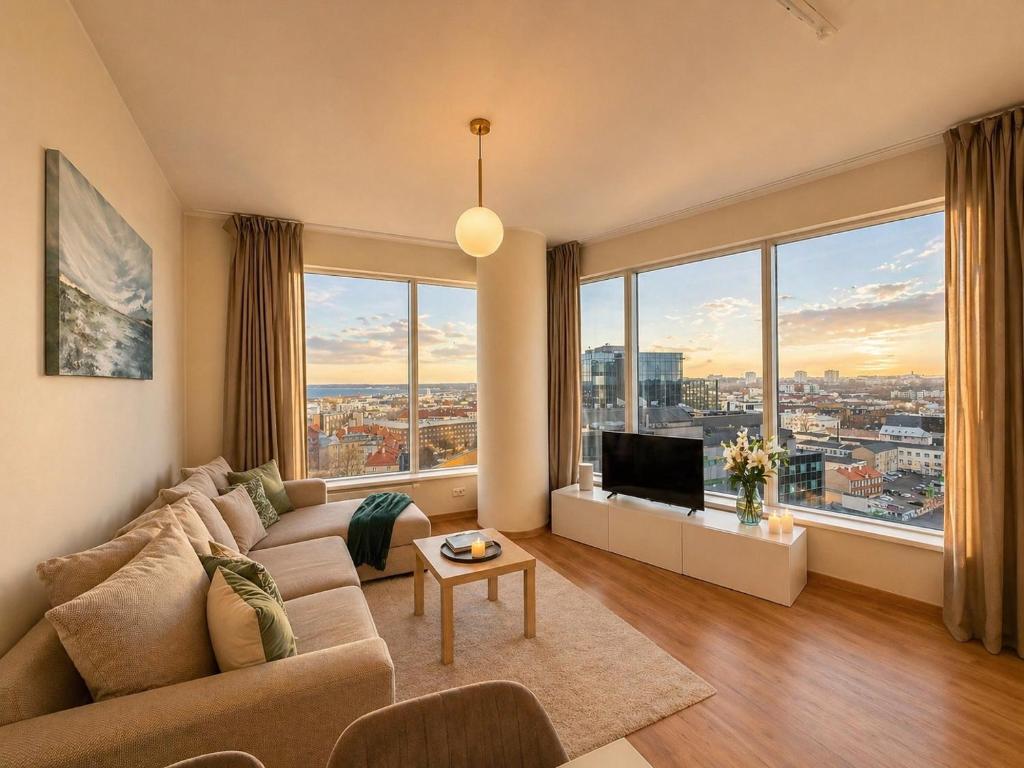 a living room with a couch and a large window at Panoramic Sea View -11th Floor in Tallinn