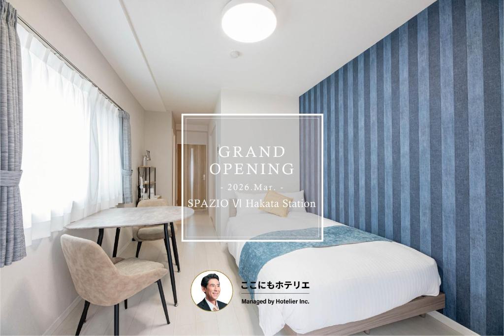a bedroom with a bed and a table and a desk at SPAZIO 6 Hakata Station in Fukuoka