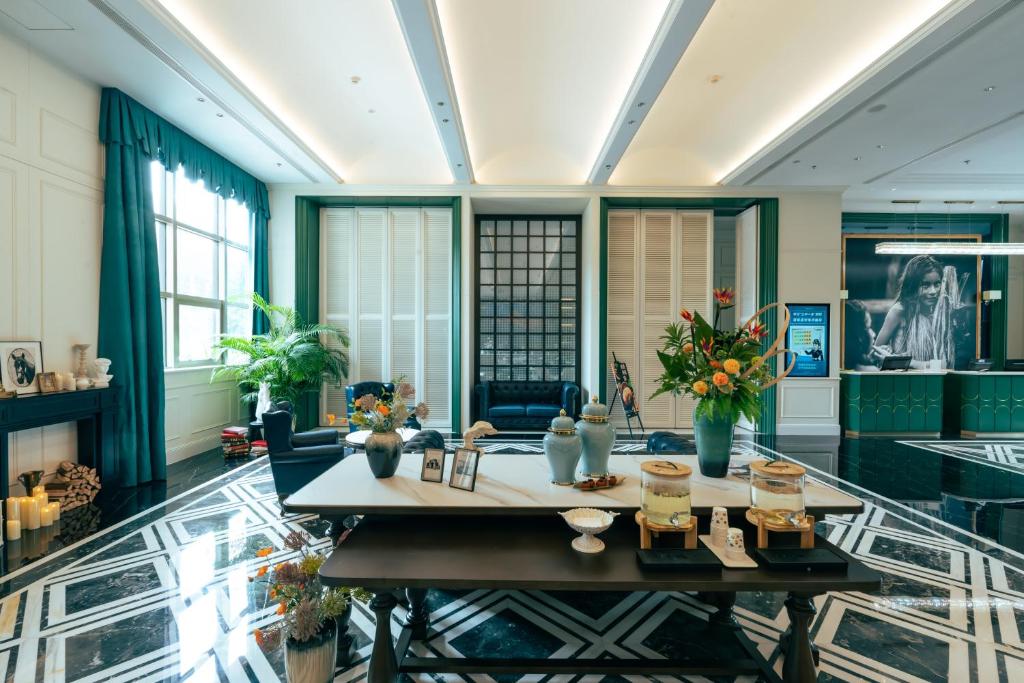 a large room with a table and chairs at JOY Hotel Hangzhou in Hangzhou