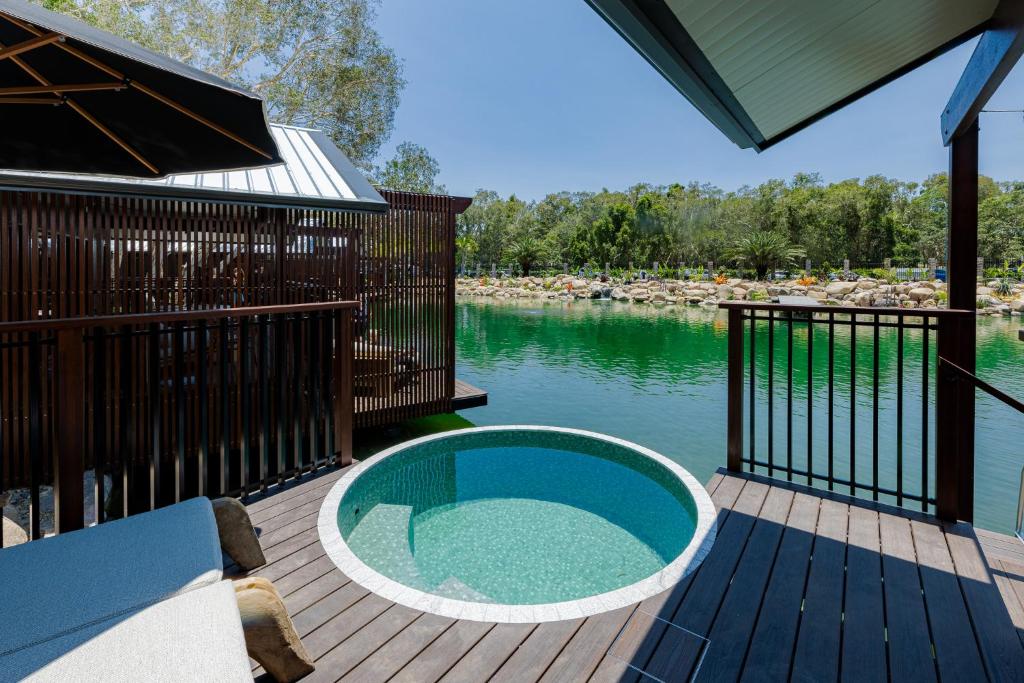 a swimming pool on a deck next to the water at BIG4 Sandstone Point Holiday Resort Bribie Island in Bongaree