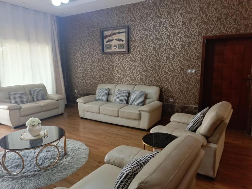 a living room with two couches and a table at Cameo Villa in Kigali