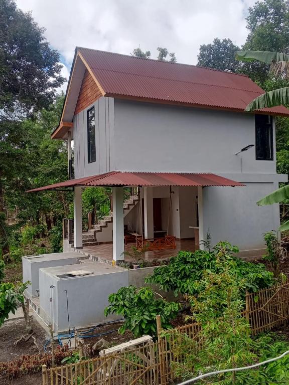 a small house with a large appliance in front of it at Jon's Paradise Villa and Resto in Sajang