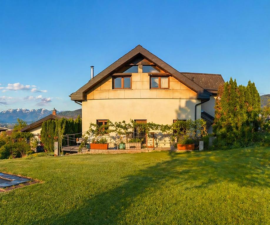 a house with a large yard in front of it at Garage Loft in Satteins