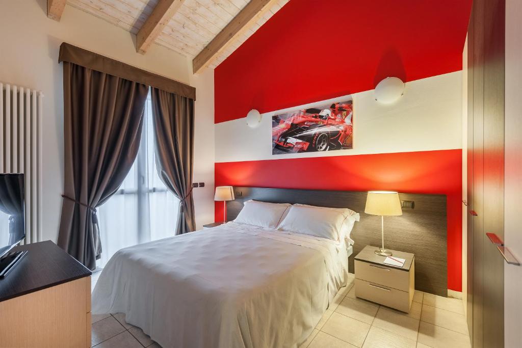 Postel nebo postele na pokoji v ubytování Hotel Maranello Village