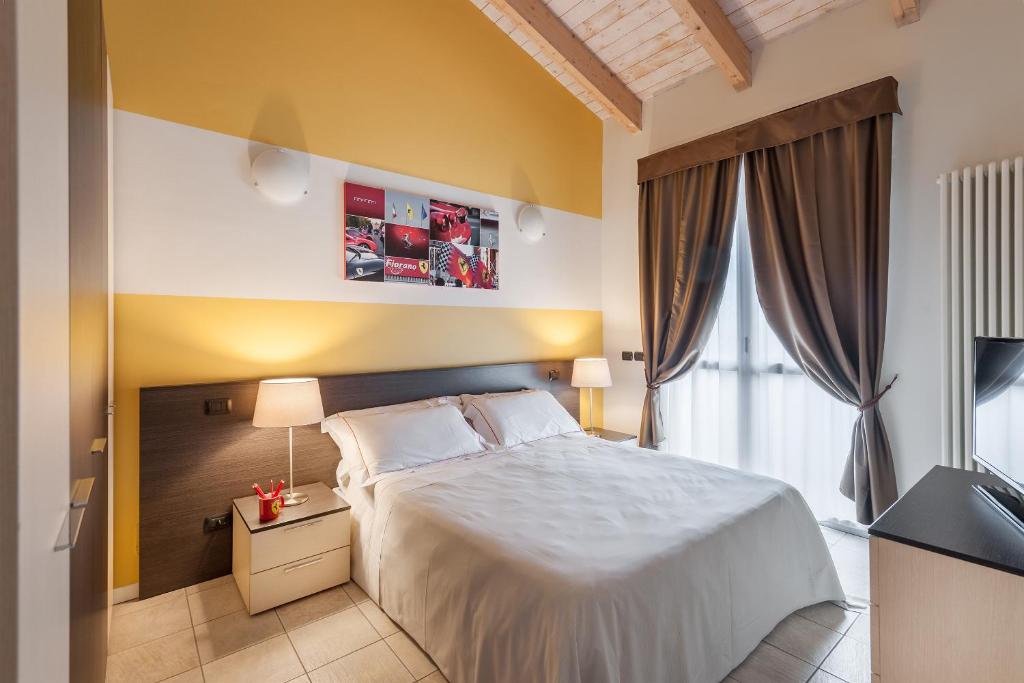 Postel nebo postele na pokoji v ubytování Hotel Maranello Village