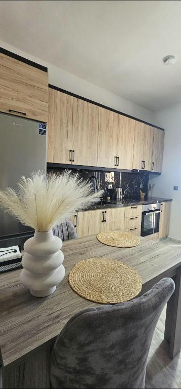 a kitchen with a table with a vase on it at Alma-Librehouse in Kefalos