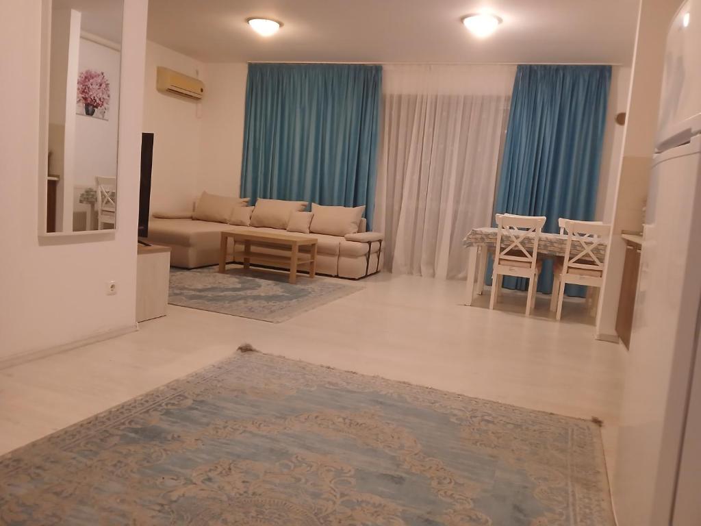 a living room with a couch and a table at Apart hotel Sara seaview in Olimp
