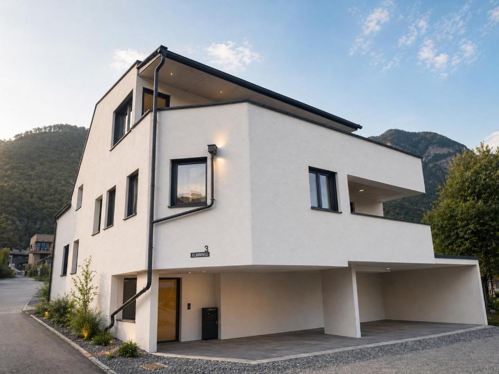 a white house with a lot of windows at Apartments Nilada in Zirl