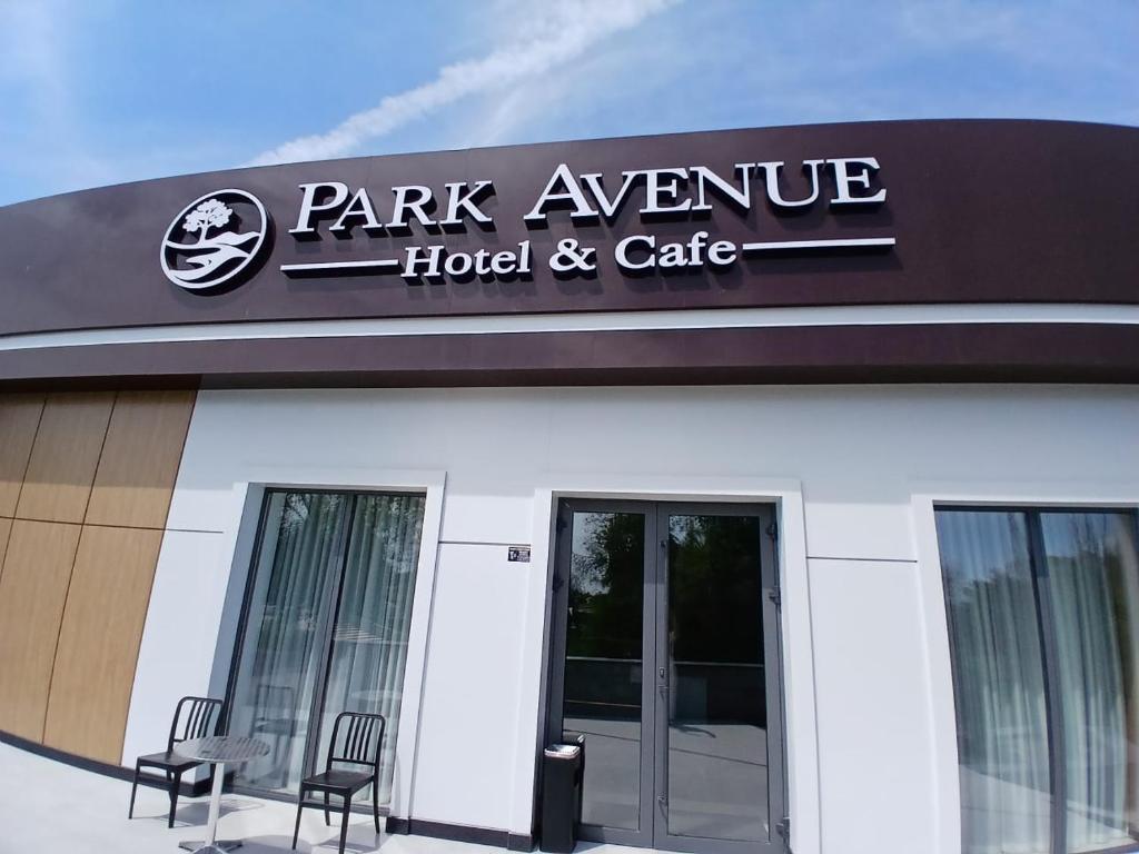 a park avenue hotel and cafe sign on a building at Park Avenue Hotel in Taraz
