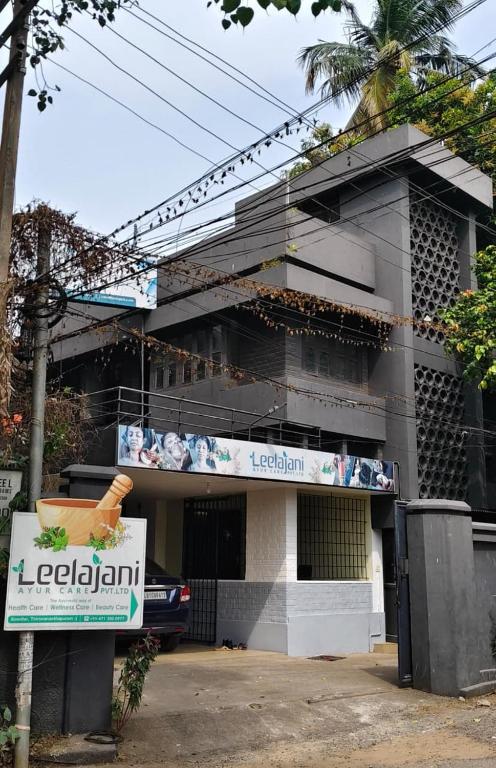 a building with a sign in front of it at Leelajani Ayurcare in Trivandrum