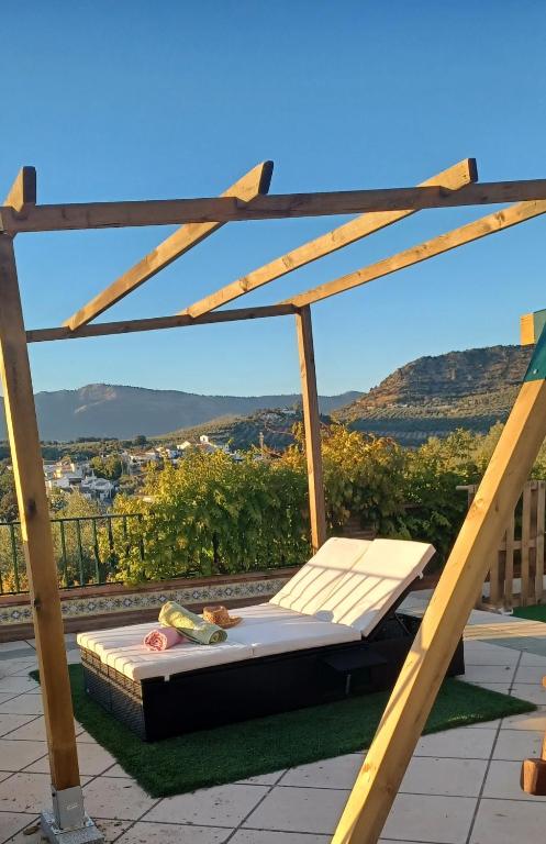 a bed sitting on top of a roof at Torre Santo Dios in Iznájar