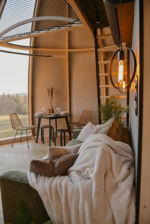 a bedroom with a bed and a table with chairs at U Bochniaka in Czorsztyn