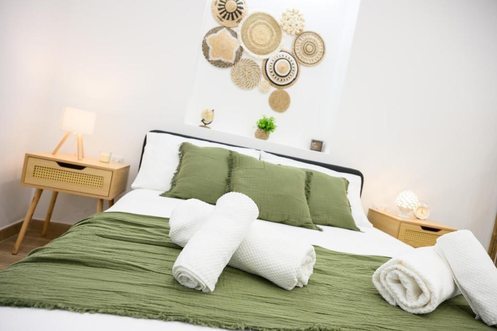 a bedroom with a bed with towels on it at ORIGINI - Dimora tra murgia e mare in Toritto