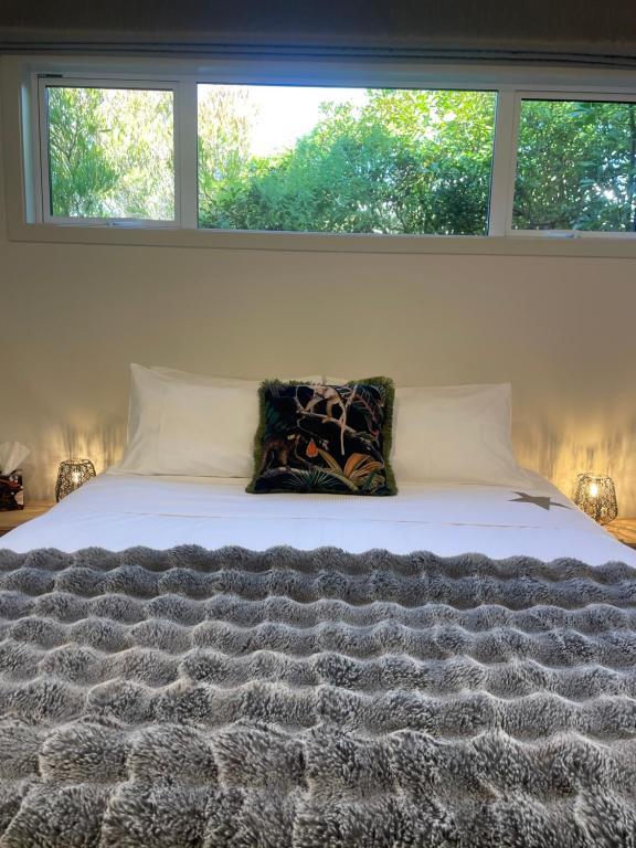 a bed with two pillows sitting on top of it at Gold Star Haven in Napier