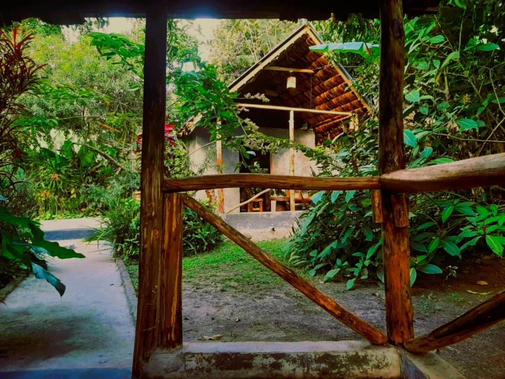 a wooden gate in front of a house at Furahia Eco Inn in Usa River