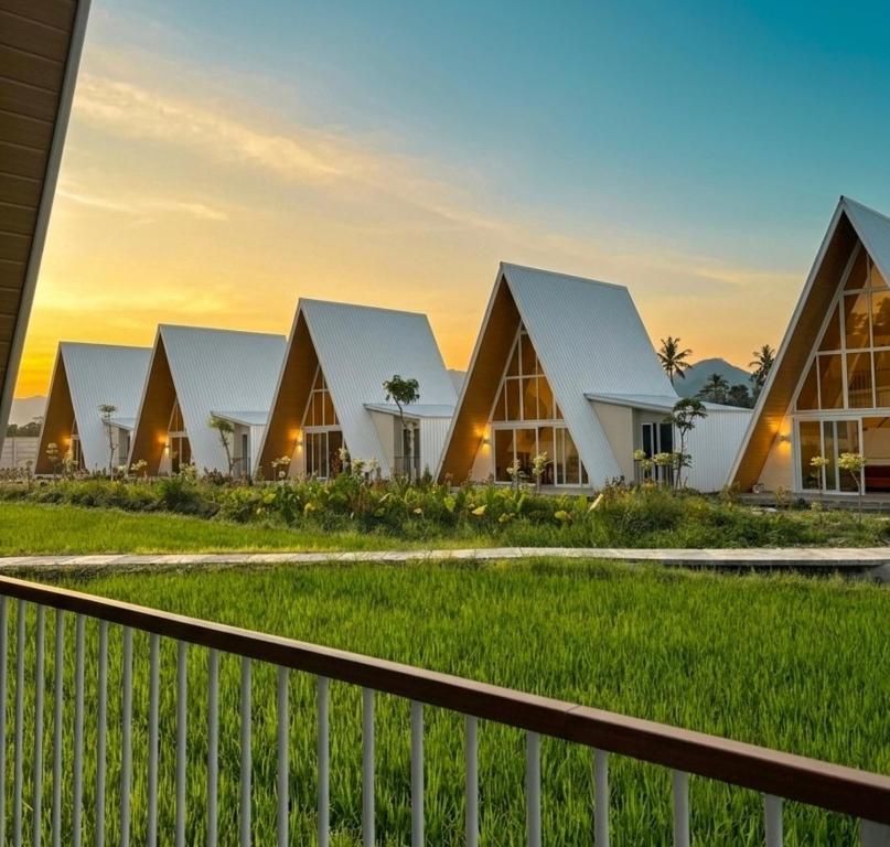 a row of houses at sunset at Grand Luxcamp Pangandaran by Horison in Pangandaran