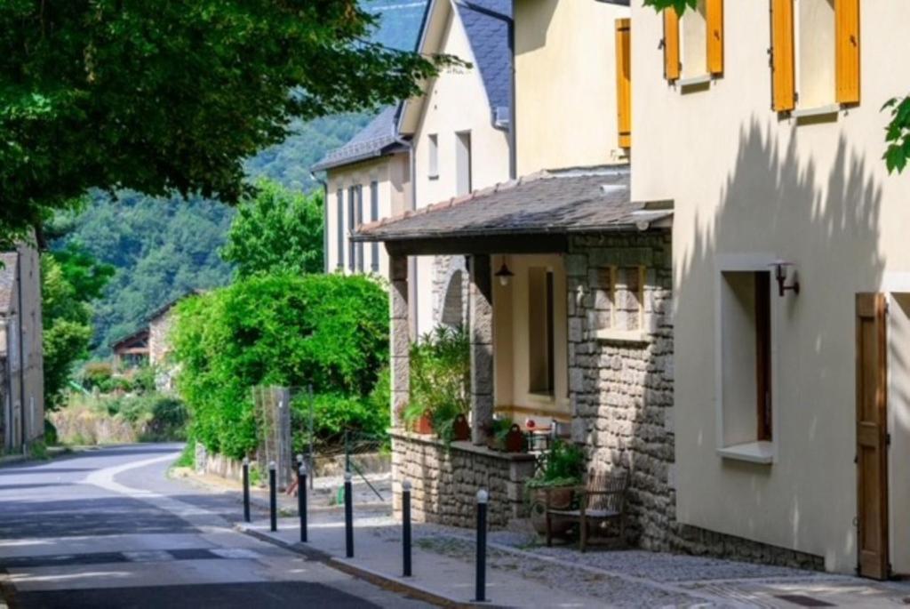 a street in a small village with a building at Hotel Restaurant de charme La Lozerette - Proche Florac in Cocurès