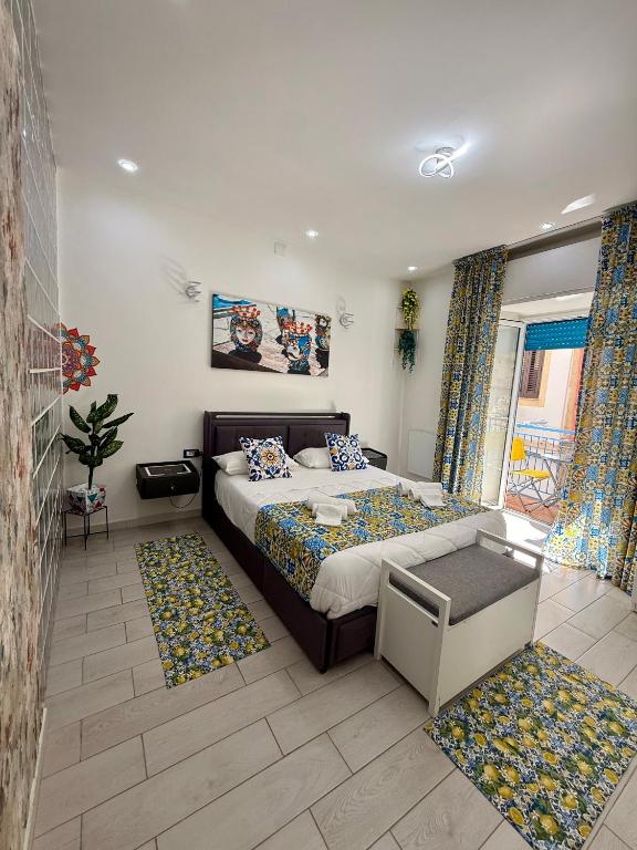 a bedroom with a bed in a room with rugs at Ballaro's Vibe Historical Apartment Cathedral District in Palermo