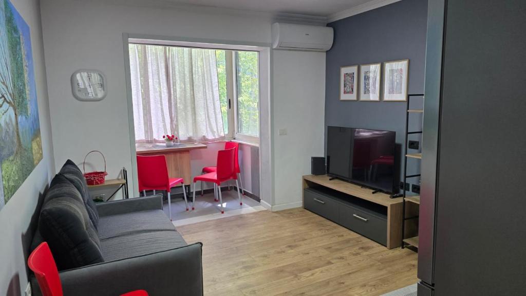 a living room with a couch and a television at AA Tirana Center View in Tirana