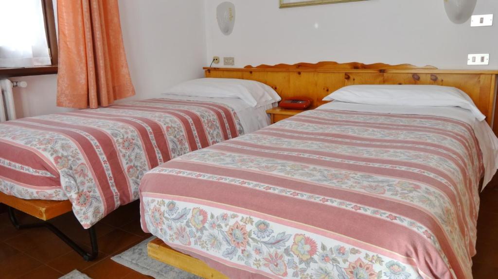 Posteľ alebo postele v izbe v ubytovaní Hotel Piccolo Mondo