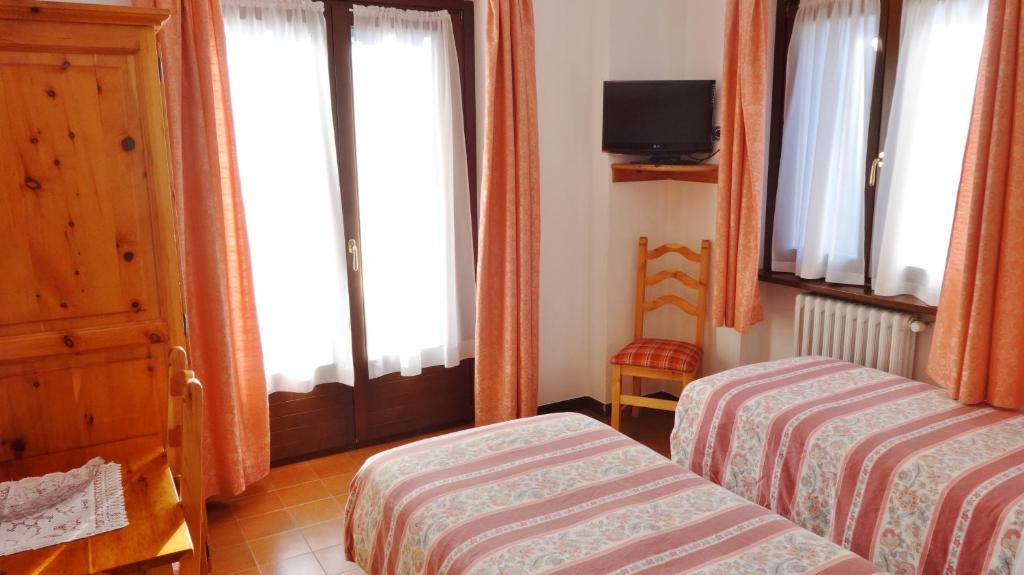 Posteľ alebo postele v izbe v ubytovaní Hotel Piccolo Mondo