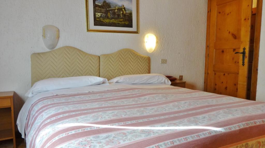 Posteľ alebo postele v izbe v ubytovaní Hotel Piccolo Mondo