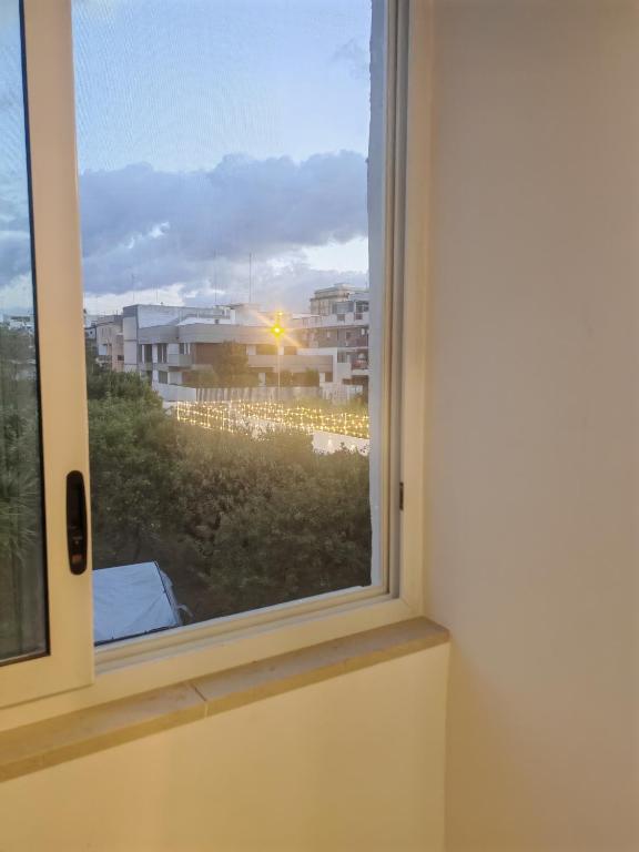 a window with a view of a building at Alighieri Rooms in Triggiano