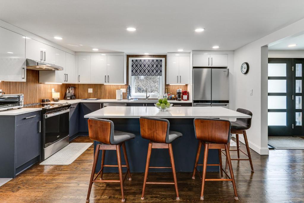 a kitchen with a large island with bar stools at Charming Connecticut Hideaway: Year-Round Fun! in Middlefield