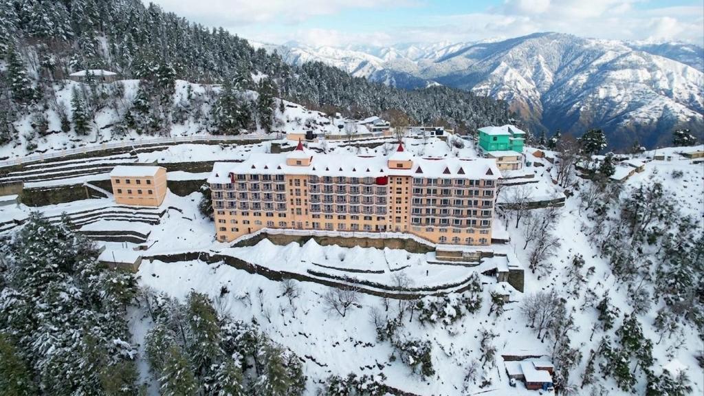 an aerial view of a hotel in the snow at Toshali Royal View ,S H I M L A in Kūfrī