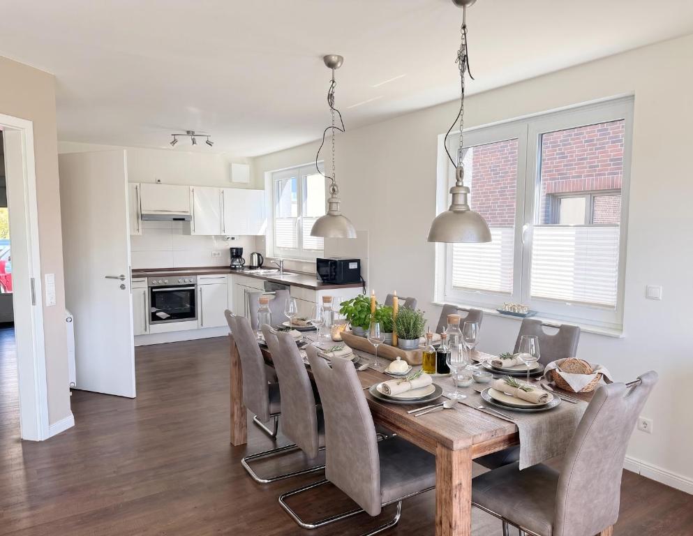 a kitchen and dining room with a wooden table and chairs at 1380- Annina 3 in Dahme