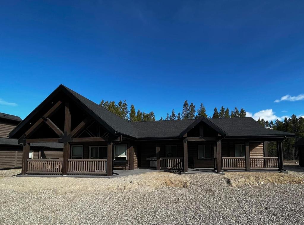 a large log cabin with a black roof at Whispering Pines Cabin in Valemount