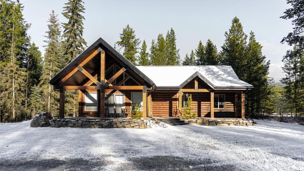 a log cabin in the woods with snow at The Highmark Cabin in Valemount