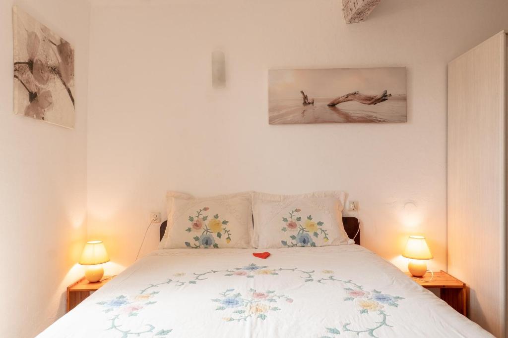 a bedroom with a bed with two pictures on the wall at La Petite Maison in Puimoisson