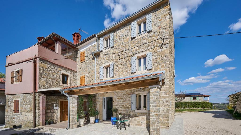 a large brick building with a blue sky in the background at Casa Pove by Villas Guide in Donje Baredine