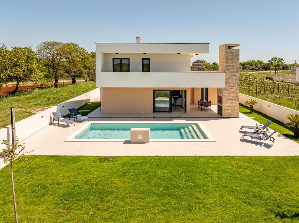 an aerial view of a house with a swimming pool at Villa Antonio ZadarVillas in Nin