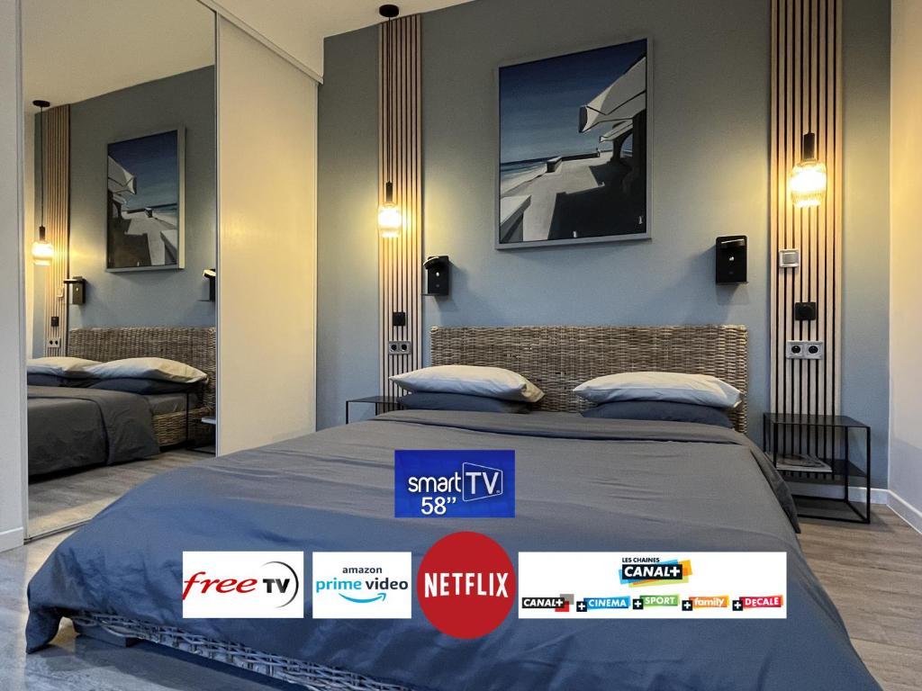 a room with two beds with signs on the wall at Studio Luxe + jardin et terrasse in Pontoise