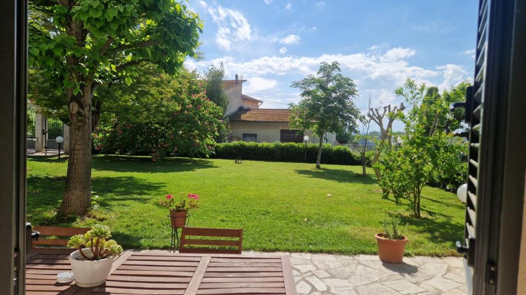 a view of a yard with a park with a bench at La CASA degli IPPOCASTANI in Colonnella