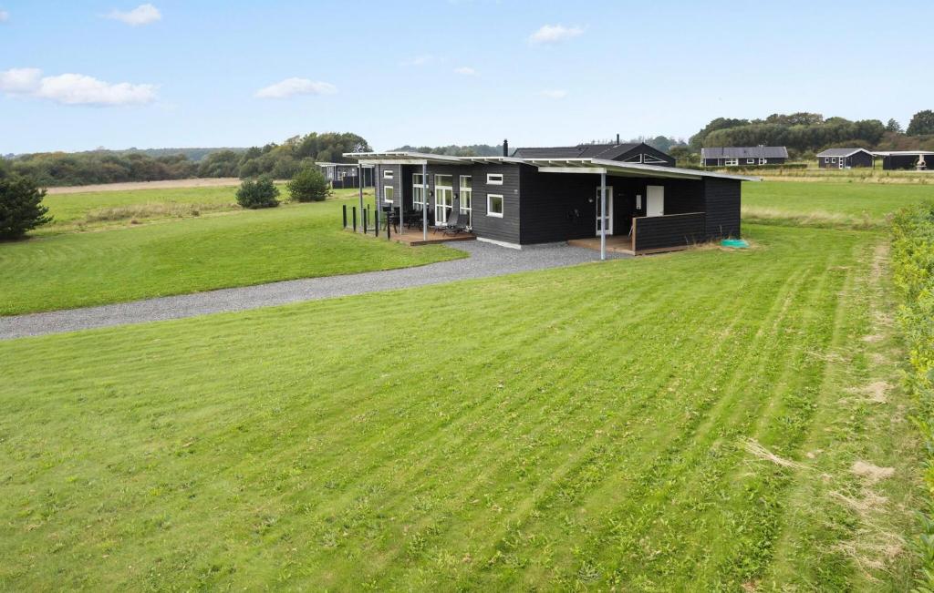 a large grass field in front of a building at Awesome Home In Haderslev With Sauna in Haderslev