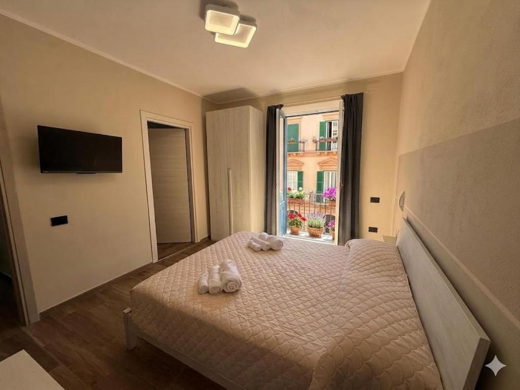 a bedroom with a bed with two shoes on it at La Rosa dei Venti in SantʼAntìoco