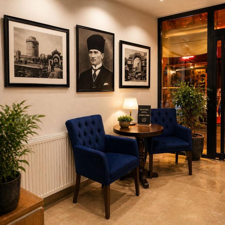 a waiting room with two blue chairs and a table at Selanikli Hotel Heybeliada in Istanbul
