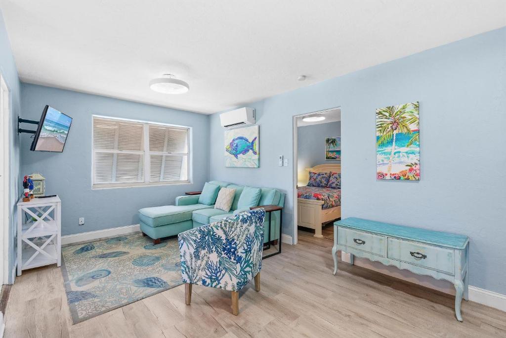 a living room with a couch and a bed at Flagler Suites 4 in New Smyrna Beach